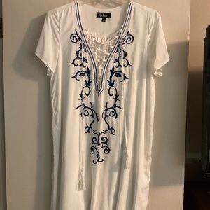 Lulus size large lined white dress with blue embroidered design on front.